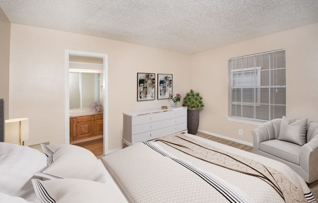 a bedroom with a bed and a dresser and a window