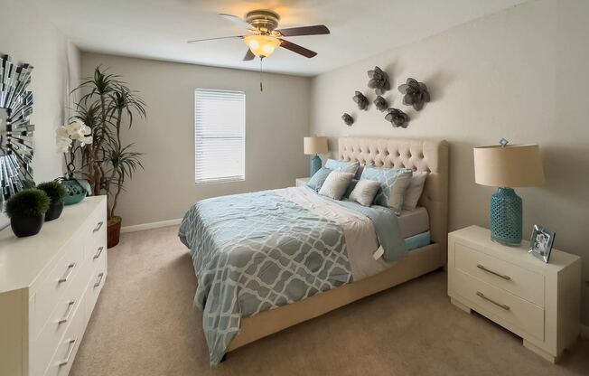 a bedroom with a bed and a ceiling fan