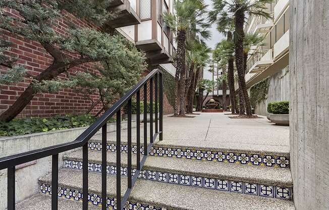 a staircase with a black railing leading up to an apartment building