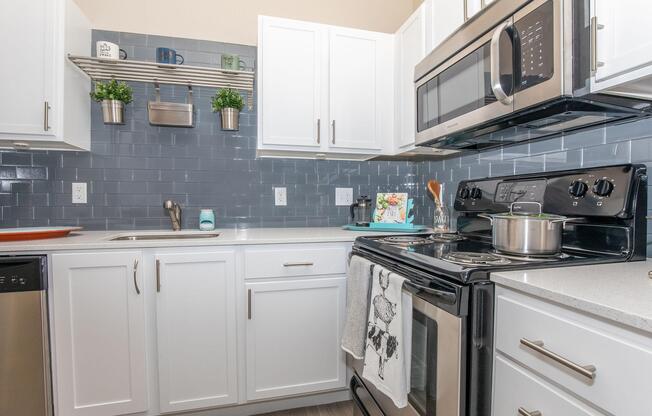 a stove top oven sitting inside of a kitchen