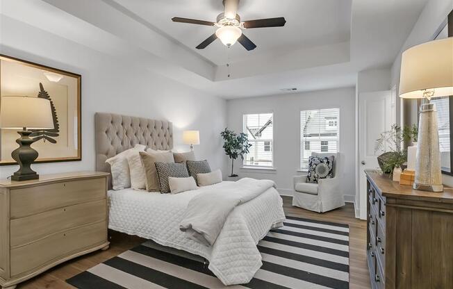 a bedroom with a bed and a ceiling fan