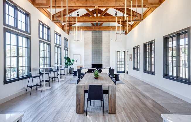 Resident lounge and co-working space with a long wooden table and chairs.