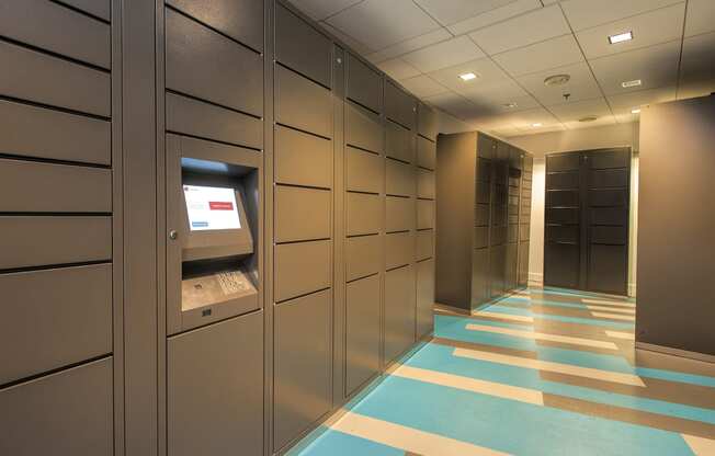 a view of a locker room with grey lockers and a blue and yellow floor