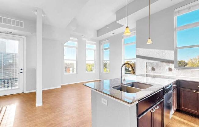 A modern kitchen with a large island and stainless steel appliances.