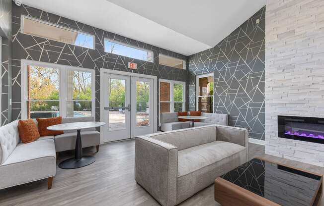 a living room with couches and tables and a fireplace