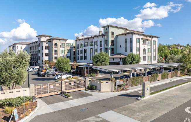 A large building complex with a parking lot in front.