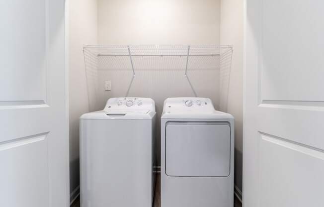 a washer and dryer in a laundry room at the oxford at estonia apartments