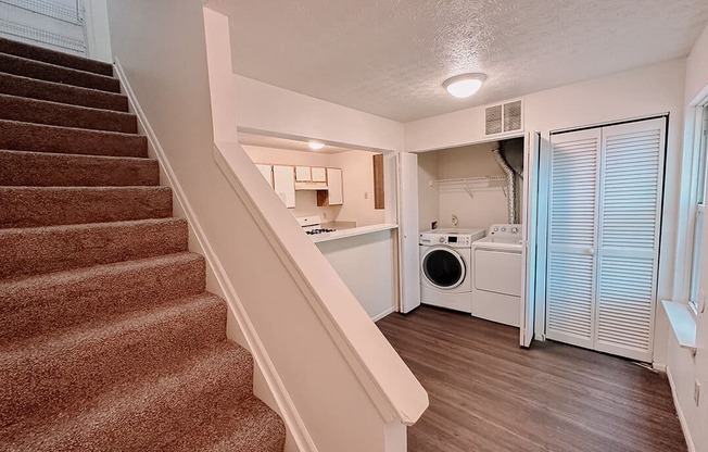 a view of a staircase and a laundry room in a home