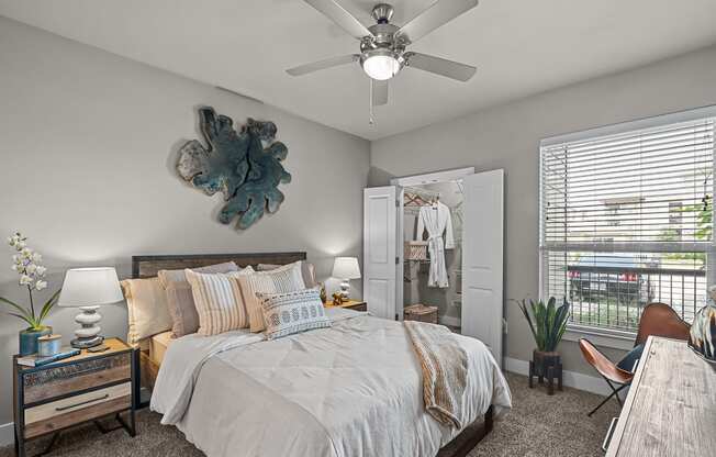 a bedroom with a large bed and a ceiling fan