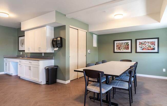 A kitchen with a table and chairs in the middle of the room.