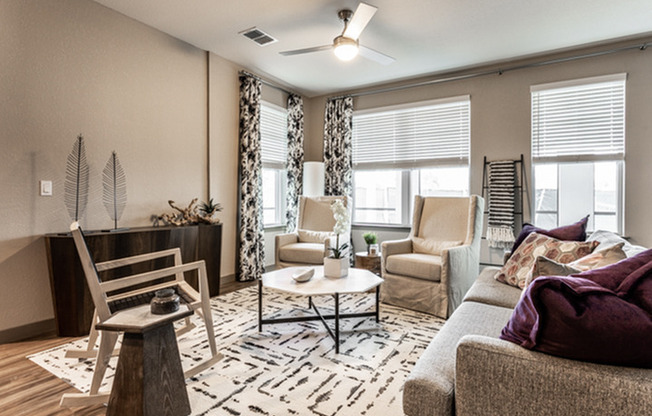 furnished living area with sofas and armchair in apartment home