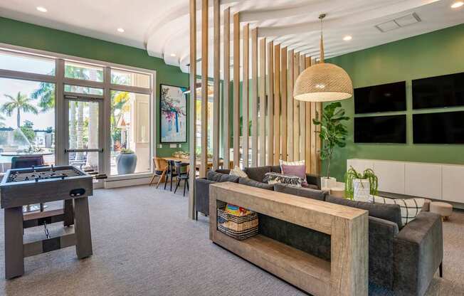 A room with a green wall and a wooden bench.