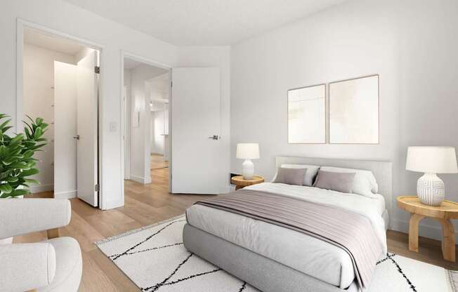 A bedroom with a large bed, a chair, and a potted plant.