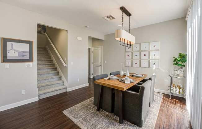 a dining room with a table and chairs