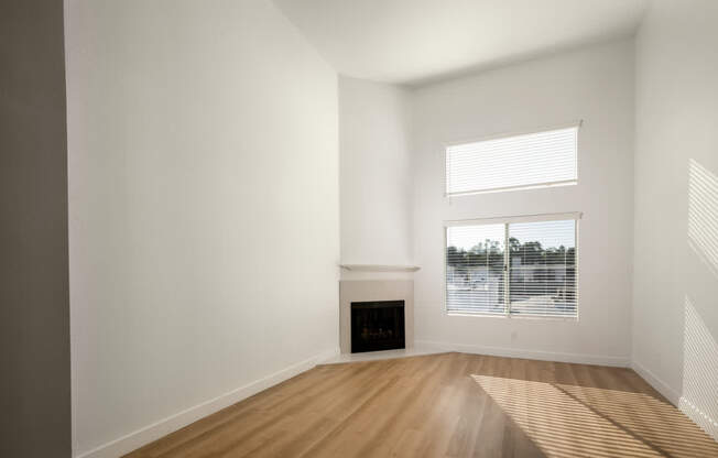 A room with a fireplace and a window.