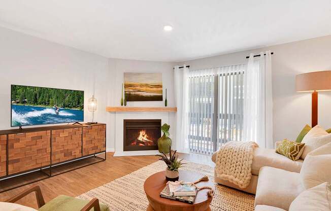 A living room with a fireplace and a television.