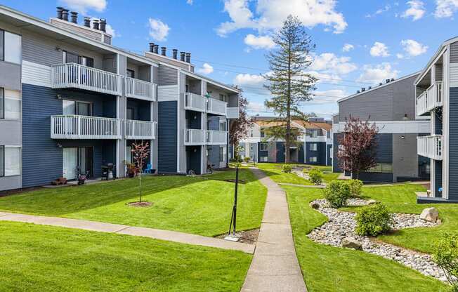 Apartment complex with a walkway between the buildings.