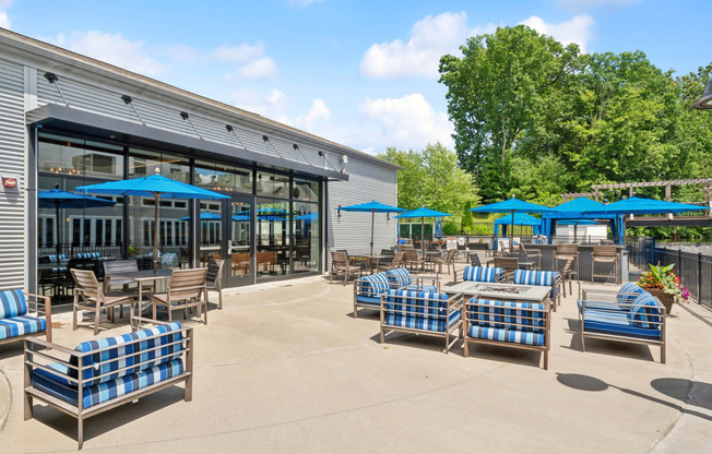 an outdoor patio with blue and white chairs and tables at The Tannery, Connecticut, 06033