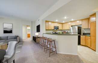 a kitchen and living room with wood cabinetry