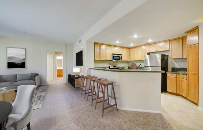 a kitchen and living room with wood cabinetry