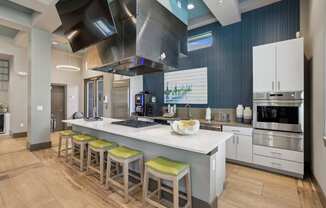 a kitchen with a large island with bar stools