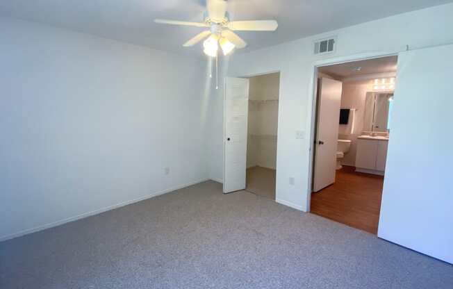 Spacious Bedroom with walk-in closet, in-suite bathroom, and multi speed ceiling fan