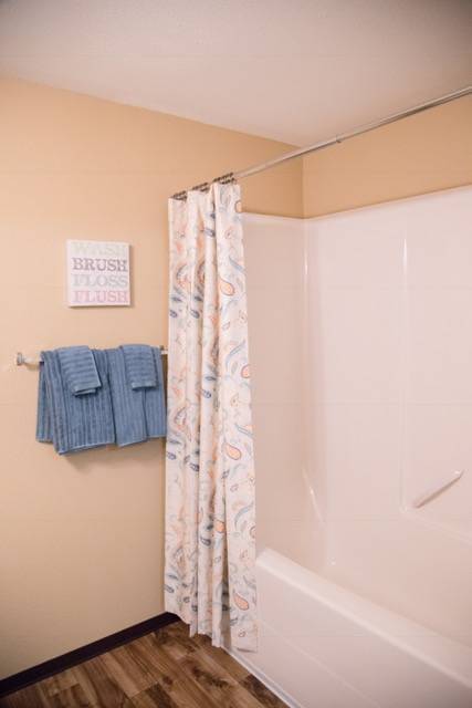 a bathroom with a shower curtain and some towels
