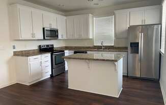 renovated furnished kitchen with wood style plank flooring