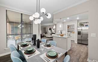 a kitchen and dining room with a table and chairs