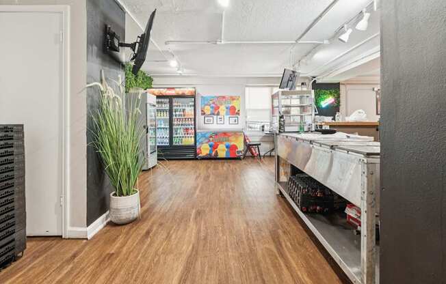 A room with a long wooden floor and a white ceiling.