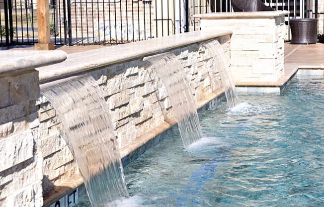 a water feature in a swimming pool at a resort