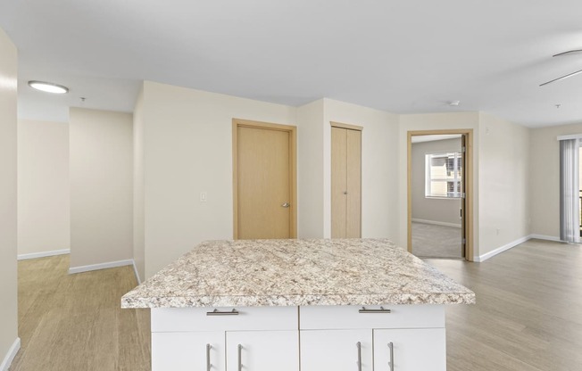 View from the Kitchen showing island with cabinets and view of living area at Promenade at the Park Apartment Homes, Seattle, 98125