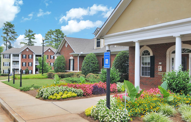Exterior of leasing office with flower beds