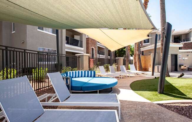 North Phoenix Luxury Apartments -Ironhorse at Tramonto Outdoor Lounge with Chairs and Large Couch Near the Swimming Pool