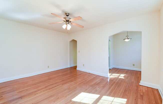 vacant living area with hardwood flooring and ceiling fan at 3101 Pennsylvania apartments in washington dc