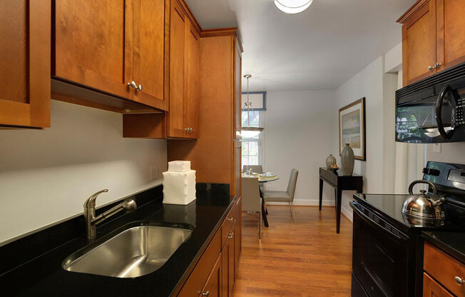 a kitchen and living room with a sink and a microwave