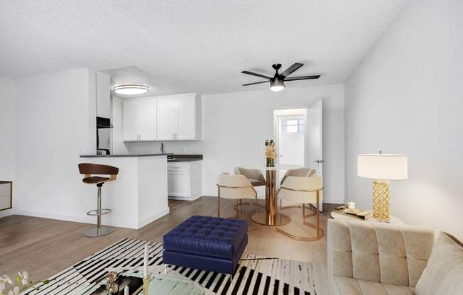 an open living room and kitchen with a table and chairs