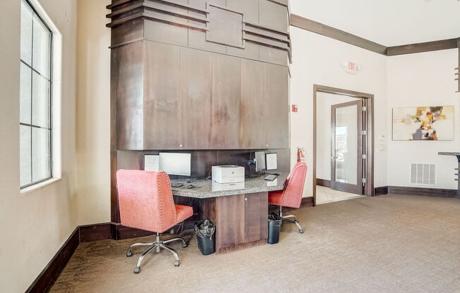 a conference room with two chairs and a desk with a microwave at Adiamo Palm Valley, Goodyear, Arizona