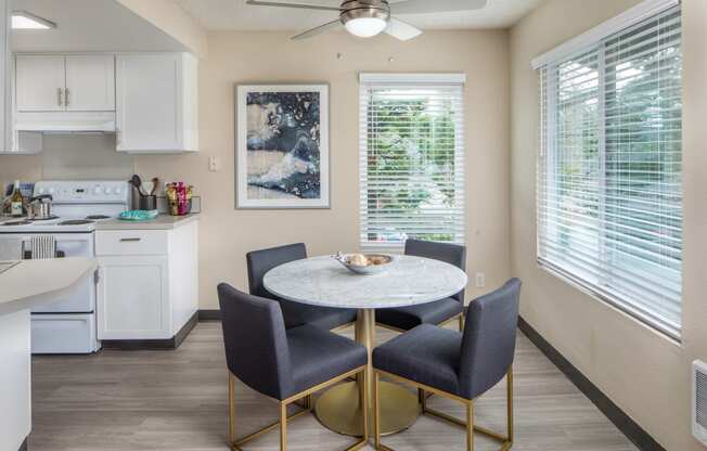 a dining room with a table and chairs and a kitchen