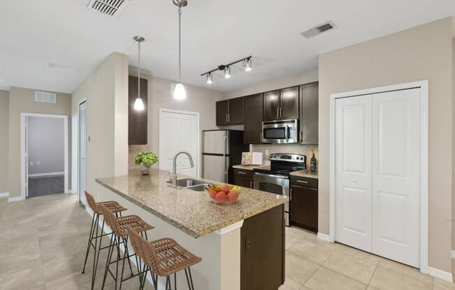 Open kitchen with upscale finishes at The Amalfi Clearwater Apartments