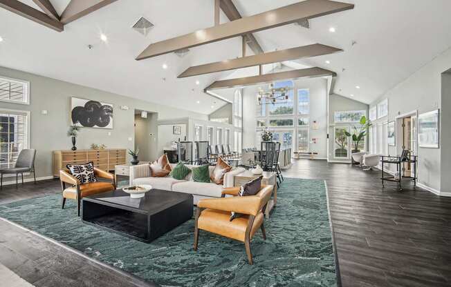 A modern living room with a black coffee table and a green rug.