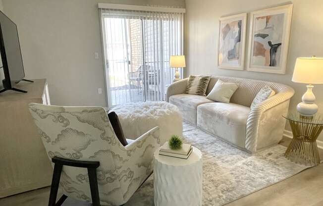 a living room with white furniture and a rug at Evergreen Luxury Apartments, Merrillville, 46410