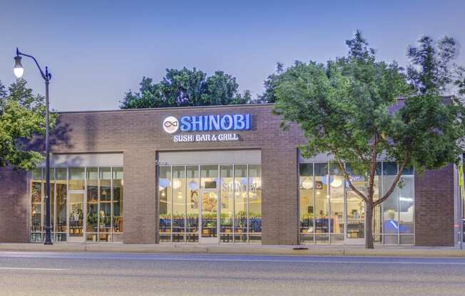 a large brick building with a sign that reads shibuya sashimi grill grill