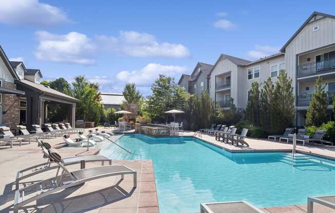 luxury swimming pool with sundeck lounging areas at Berkshire Aspen Grove apartments