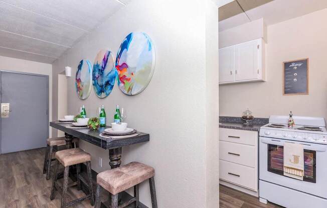 A white kitchen with a stove and a fridge.