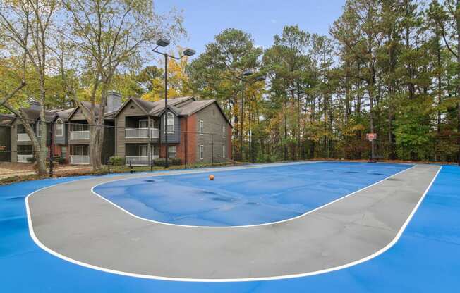 a basketball court with apartments in the background at Woodmere Trace at Duluth, GA