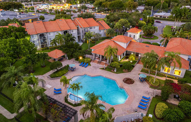 A large building with a pool in front of it.