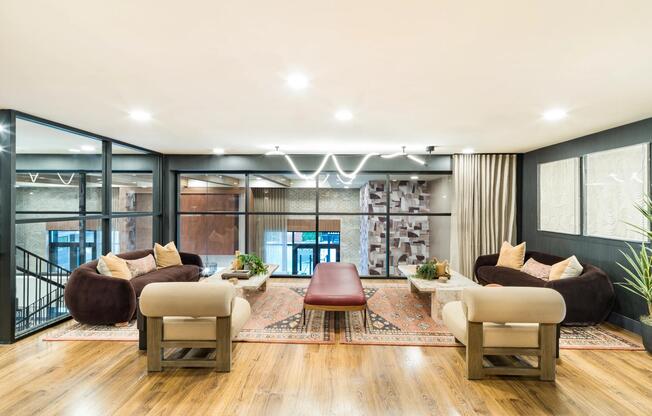 An inviting resident lounge at Modera Higley Commons, designed with layered seating, warm finishes, and a relaxed setting for everyday connection.