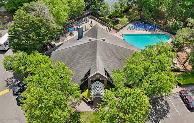 A large building with a pool in front of it.
