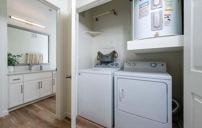A white washing machine and dryer in a small laundry room.